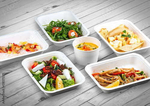 A set of healthy food dishes in ecological packaging on a wooden background. Food delivery. Takeaway.