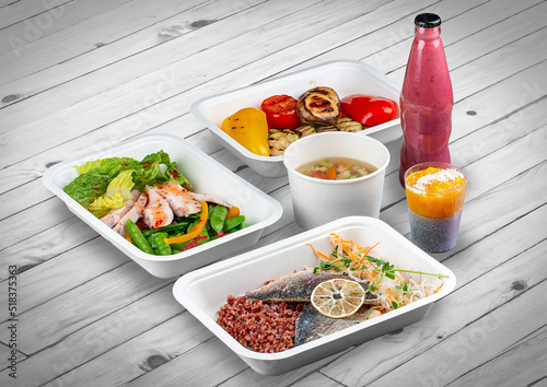 A set of healthy food dishes in ecological packaging on a wooden background. Food delivery. Takeaway.