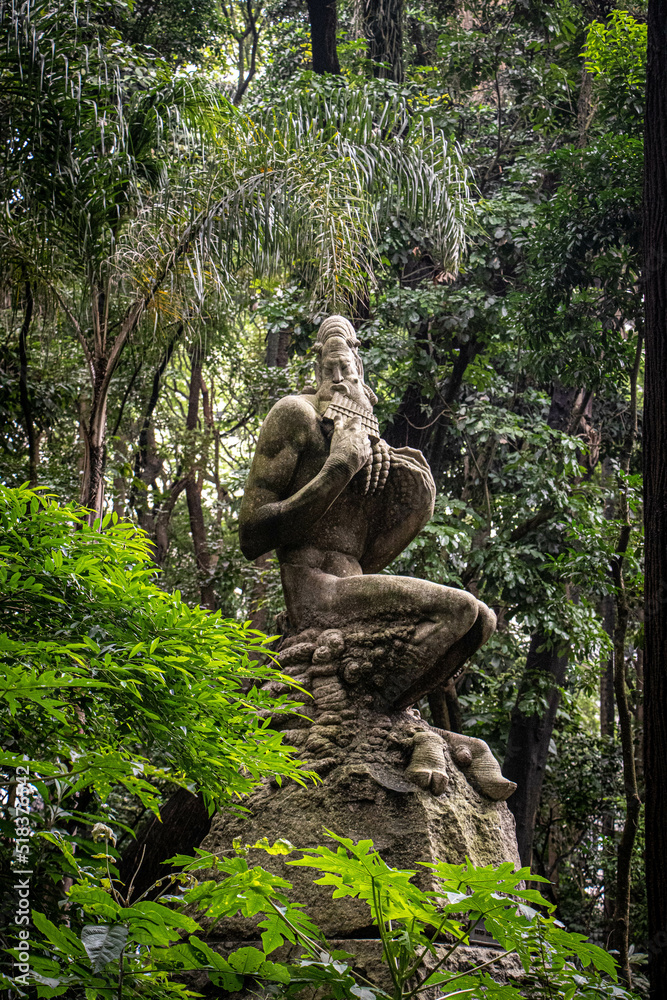 statue in the middle of tropical forest