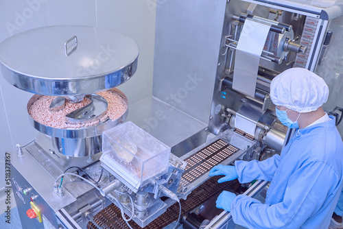 Quality Control Workers Examining Pills in Lab photo