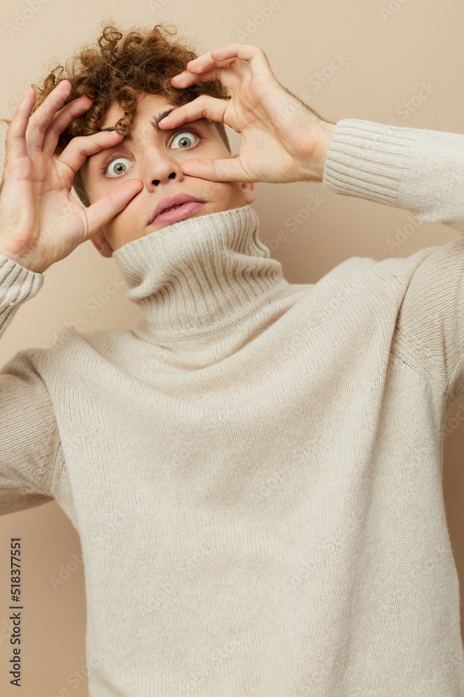 vertical portrait of a funny man in a light turtleneck making a funny face with his eyes wide open vertical portrait of a funny man in a light turtleneck making a funny face with his eyes wide open