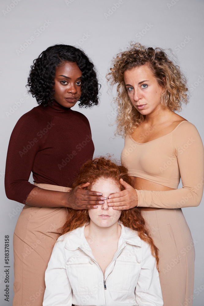 Women covers another's eyes Women covers another's eyes