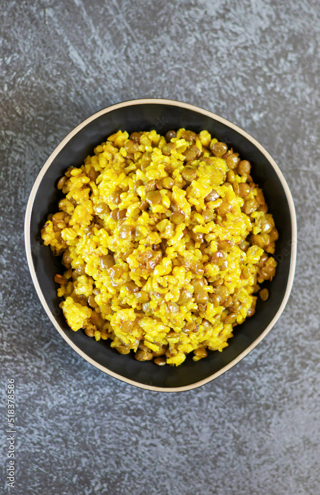 Traditional Middle Eastern dish Mujadara: lentils and rice on a dark background Traditional Middle Eastern dish Mujadara: lentils and rice on a dark background