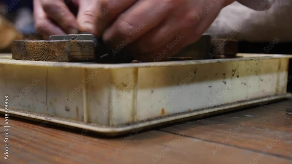 Master swordsmith is sharpening knife on grindstone with water Master swordsmith is sharpening knife on grindstone with water