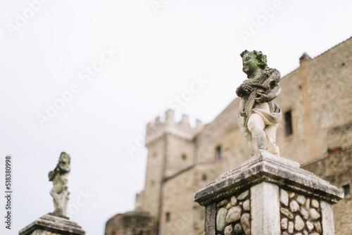 Stone sculptures of angels with violins on the turrets of the castle Orsini - Odescalchi in Nerola, Rome. photo