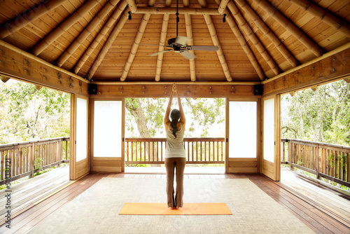Woman doing yoga in Japanese yoga deck pavilion photo