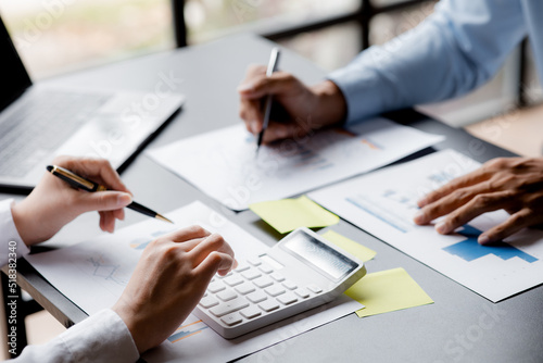 A conference room where executives and marketers are looking at sales documents to analyze, plan marketing and do sales promotions, they are brainstorming. Sales management concept.