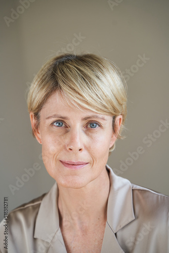 Glad middle aged woman looking at camera