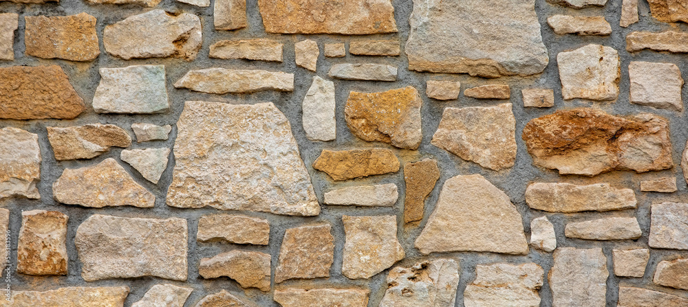 Texture of a stone wall. Old castle stone wall texture background. Banner Texture of a stone wall. Old castle stone wall texture background. Banner