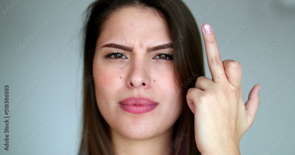 Girl gives the finger to camera, woman showing middle finger, offensive language Girl gives the finger to camera, woman showing middle finger, offensive language
