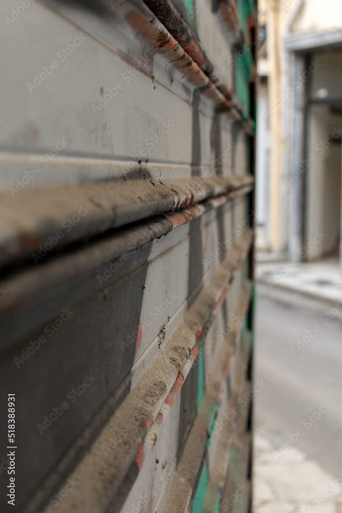 Close up view of closed shop roll with graffiti on it
Close up view of closed shop roll with graffiti on it