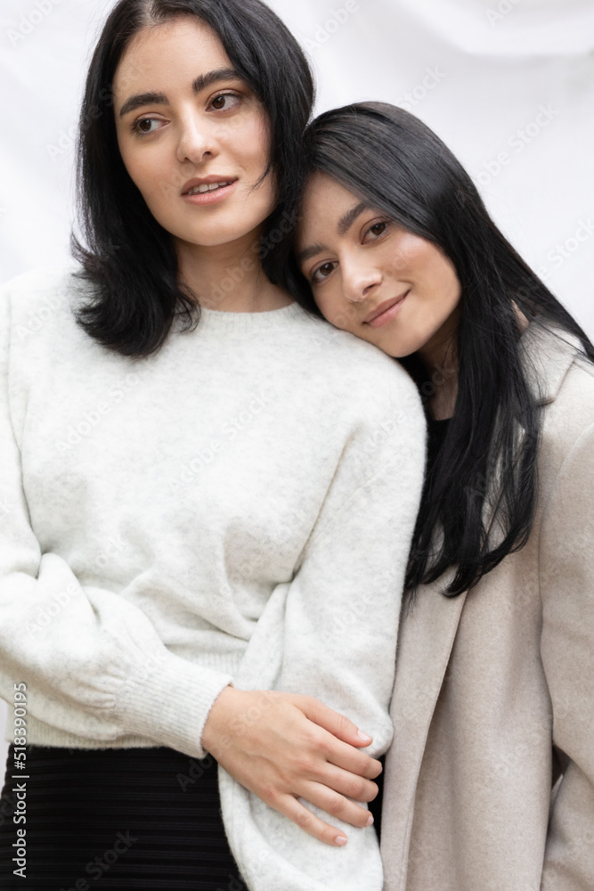 Attractive twin sisters in black and white minimal aesthetic
