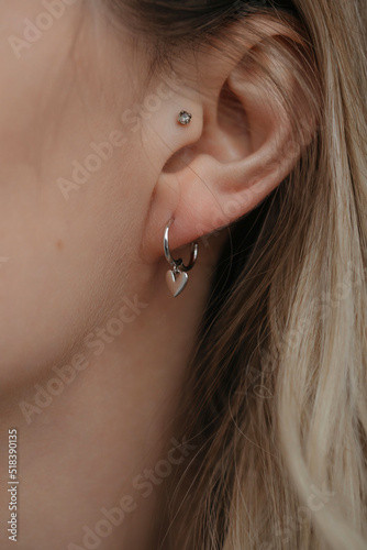 Closeup ear with earrings and piercing  photo