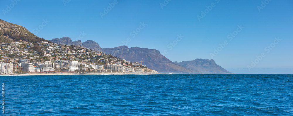 Sea Point and the Twelve Apostles with Table Mountain in the background during summer in Cape Town, South Africa. Scenic banner landscape views of the ocean against a clear blue sky for tourism