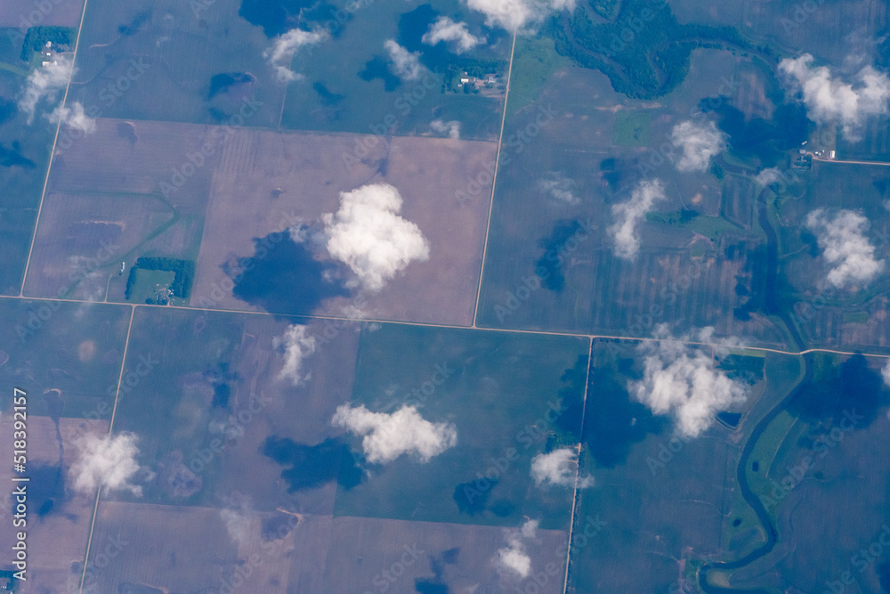 Aerial view of the midwest United States featuring farms in Minnesota as seen through clouds Aerial view of the midwest United States featuring farms in Minnesota as seen through clouds