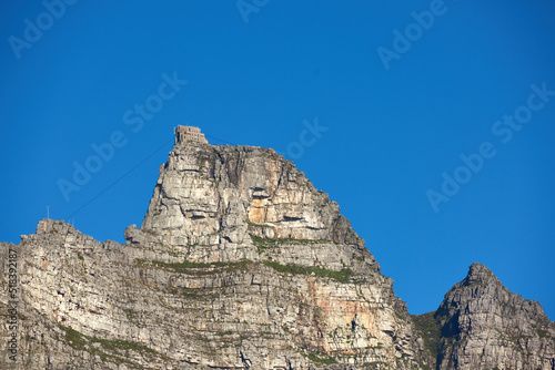 A mountain cable car station for transporting tourists up Table Mountain, Cape Town to view nature. Low angle of rough, rocky, or dangerous terrain in a remote location with tropical weather