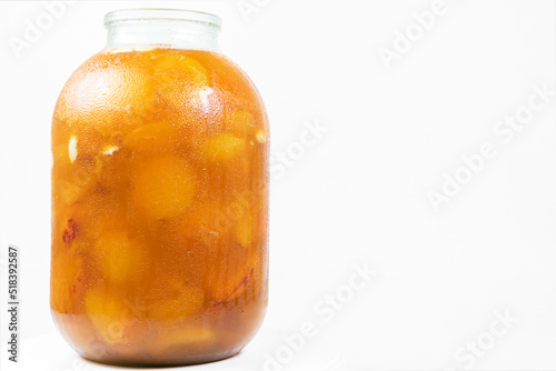 Jar with apricot jam isolated on white background