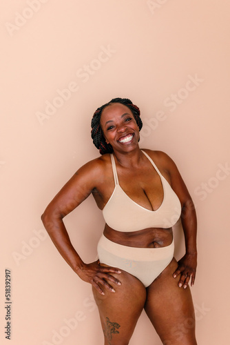 Radiant black woman posing in underwear