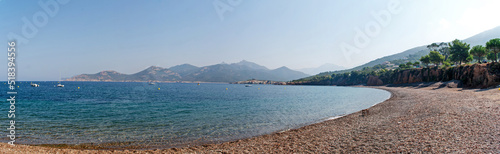 Beach with crystal clear azure sea and coastline on Corsica, France