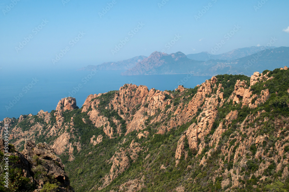 Evening view of the sun-lit mountains and sea - Corsica, Calanche region