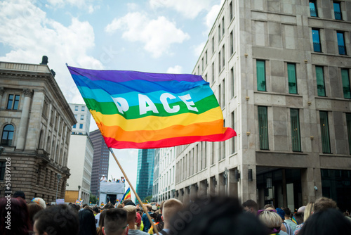 Pace flag waving during Pride Procession in the city centre