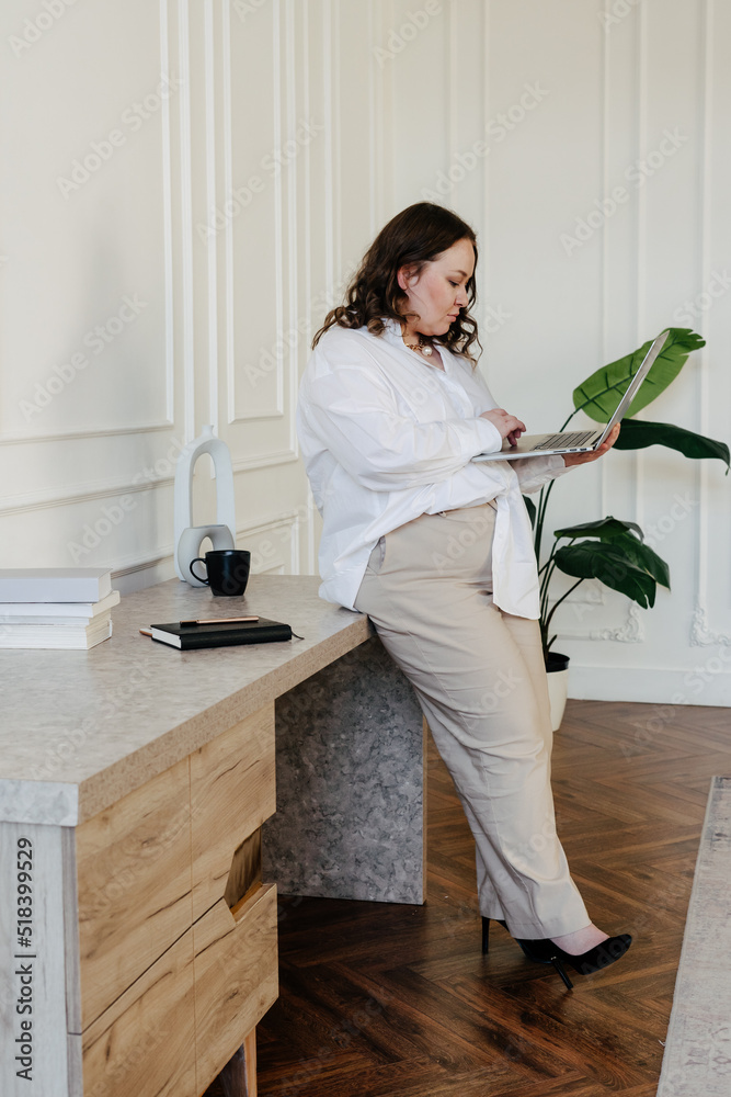 Serious businesswoman using laptop at workplace Serious businesswoman using laptop at workplace