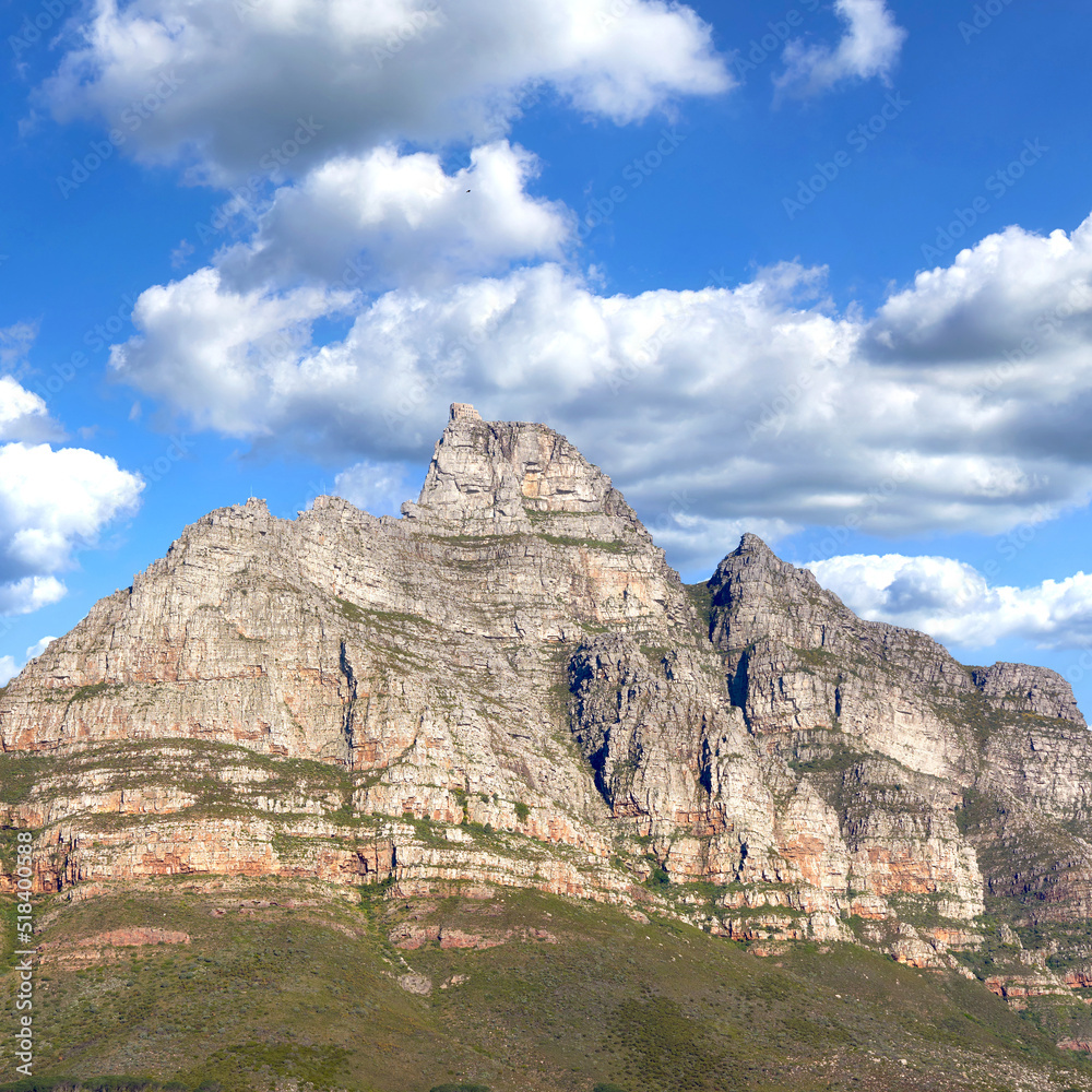 Rocky mountain landscape with green pasture against a blue sky with copyspace. A popular travel destination for tourists and hikers to explore. View of Table Mountain in Cape Town, Western Cape