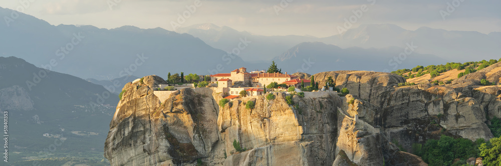 Stone monastery in the mountains. Kalabaka, Greece summer cloudy day in Meteora mountain valley. panoramic photo close up