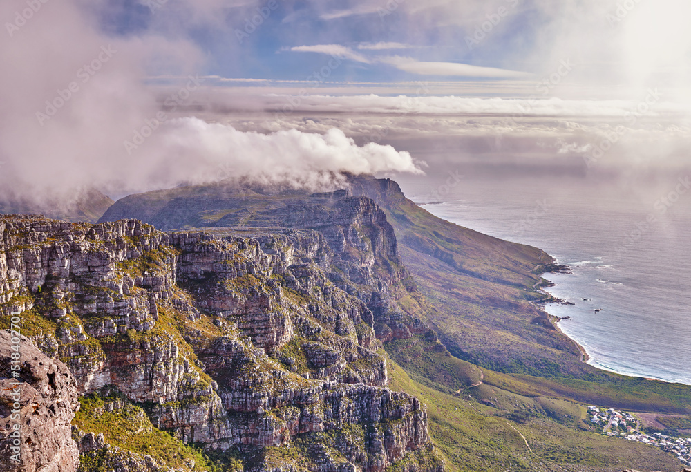Scenic landscape view of Table Mountain in Cape Town, Western Cape during summer. Beautiful scenery of clouds rolling over a natural landmark on a foggy and misty day in South Africa with copyspace