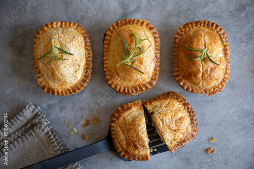 Fotografija mini meat pies with golden crust, homemade, top view, grey background