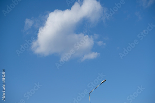 white peaceful sky, white cirrus clouds, beautiful sunny sky, blue sky, yellow lantern, minimalism, building, construction