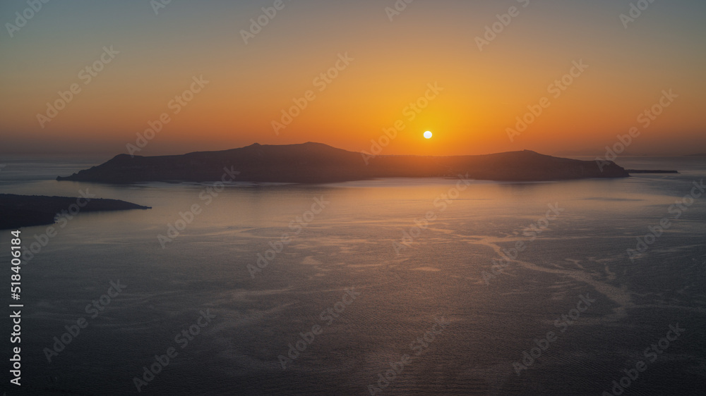 Amazing landscape with a beautiful sunset on Thirasia island viewd from Santorini, Greece - obrazy, fototapety, plakaty 