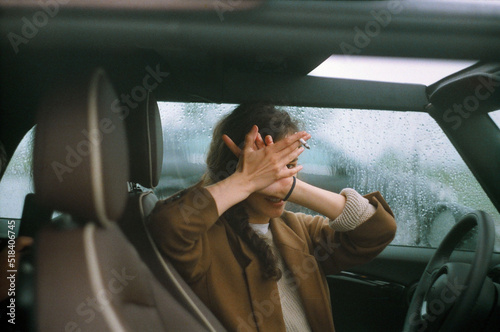 A woman in a car in a rainy day