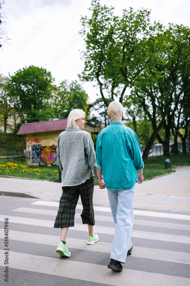Woman following road rules, while crossing pedestrian with girlfriend Woman following road rules, while crossing pedestrian with girlfriend