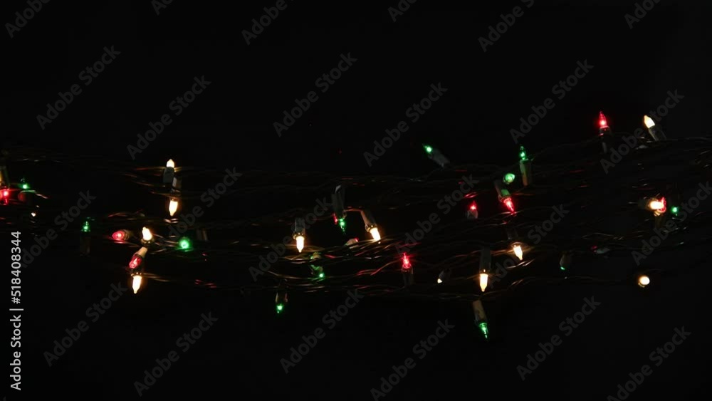 Blinking red, white and green small bulb string lights on black