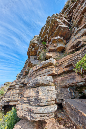 Landscape scenic view of Table Mountain in Cape Town, South Africa against a blue sky in summer. Closeup of rocks on a natural landmark in a popular tourist city for hiking and adventure in nature