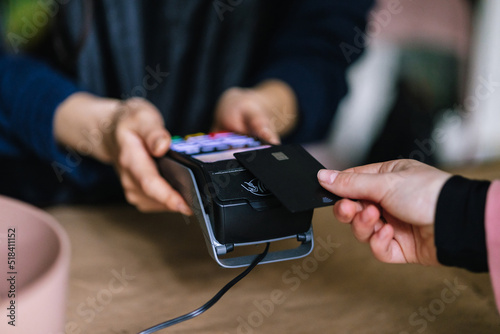 Client paying for order with contactless credit card  photo