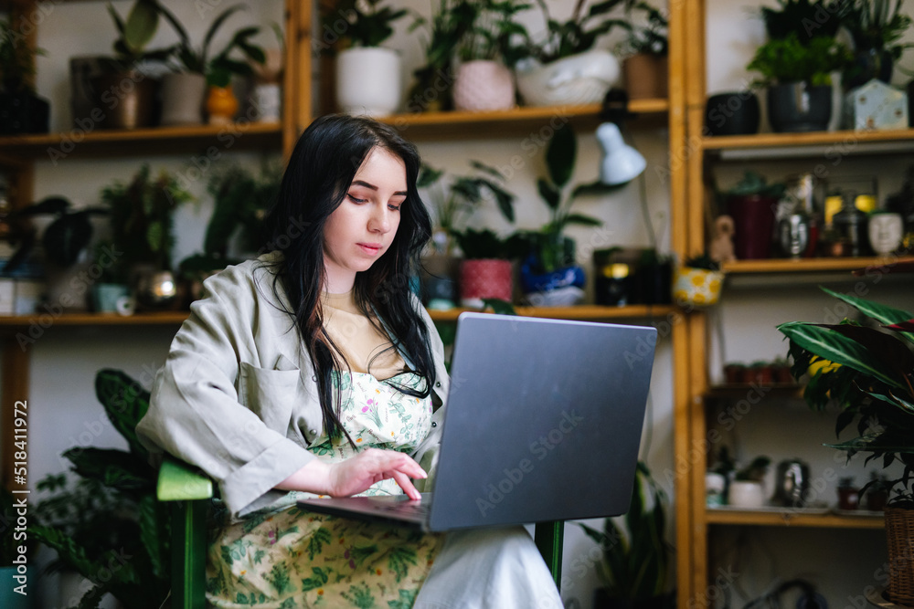 Saleswoman checking online orders from customers Saleswoman checking online orders from customers