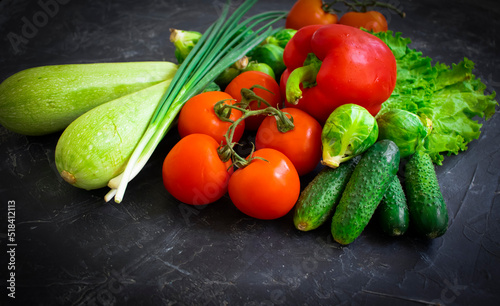 Fresh different vegetables on dark background