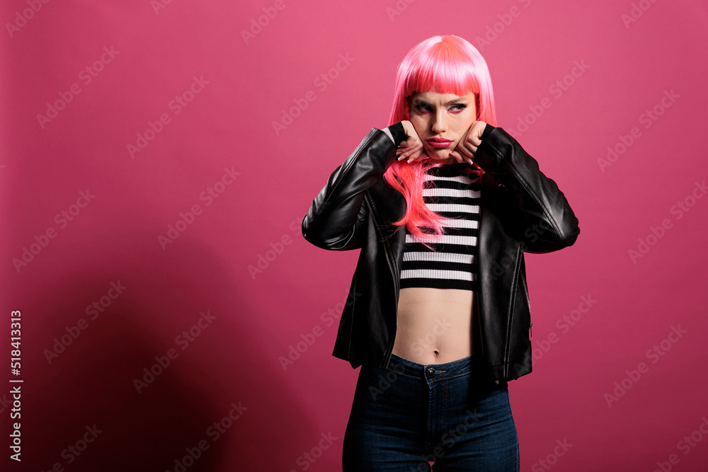Portrait of attractive pretty woman wearing sexy leather jacket to advertise rocker fashion style with punk hairstyle. Carefree model feeling stylish and confident with elegant clothes in studio. Portrait of attractive pretty woman wearing sexy leather jacket to advertise rocker fashion style with punk hairstyle. Carefree model feeling stylish and confident with elegant clothes in studio.
