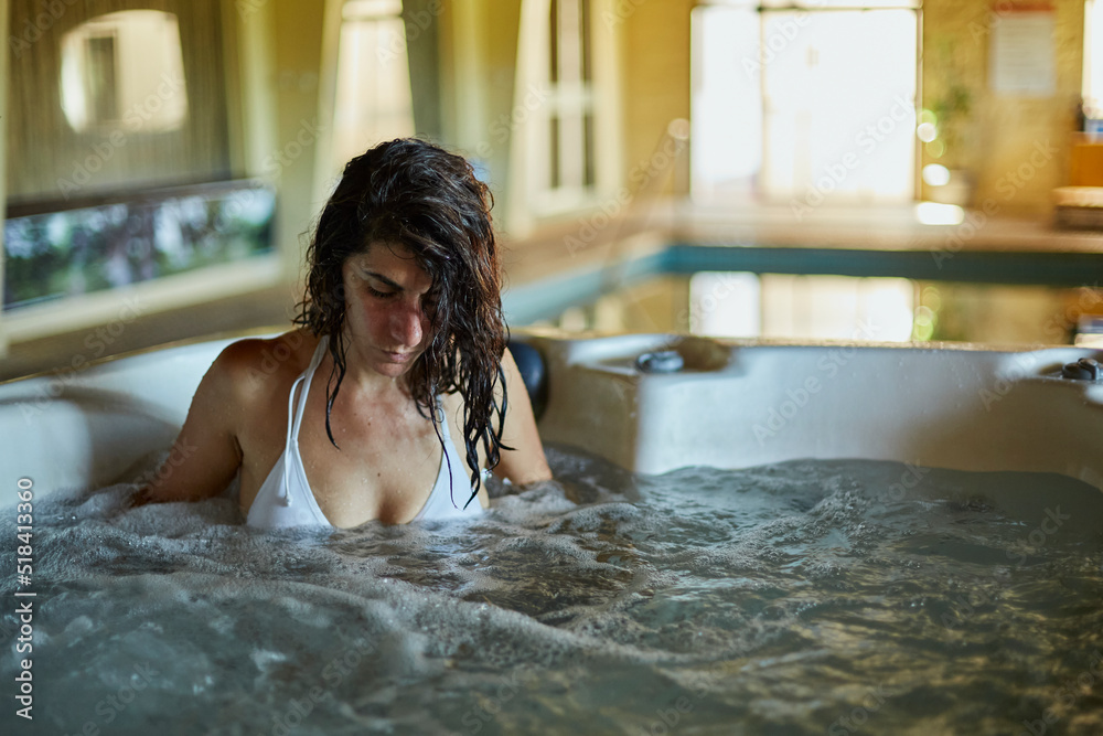 closeup of a beautiful woman relaxing in a hotel jacuzzi during her vacation