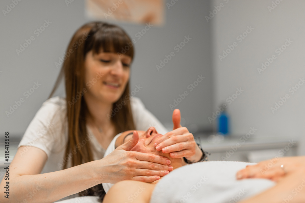 woman receiving facial massage woman receiving facial massage