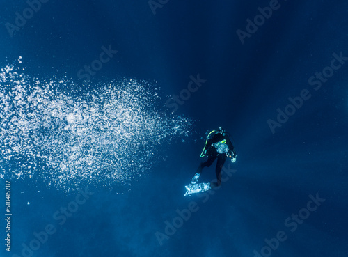 Woman ascending into the clear water at the Tubbataha Reef photo