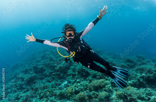 Wallpaper Mural Woman ascending into the clear water at the Tubbataha Reef Torontodigital.ca