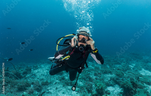 Wallpaper Mural Woman ascending into the clear water at the Tubbataha Reef Torontodigital.ca