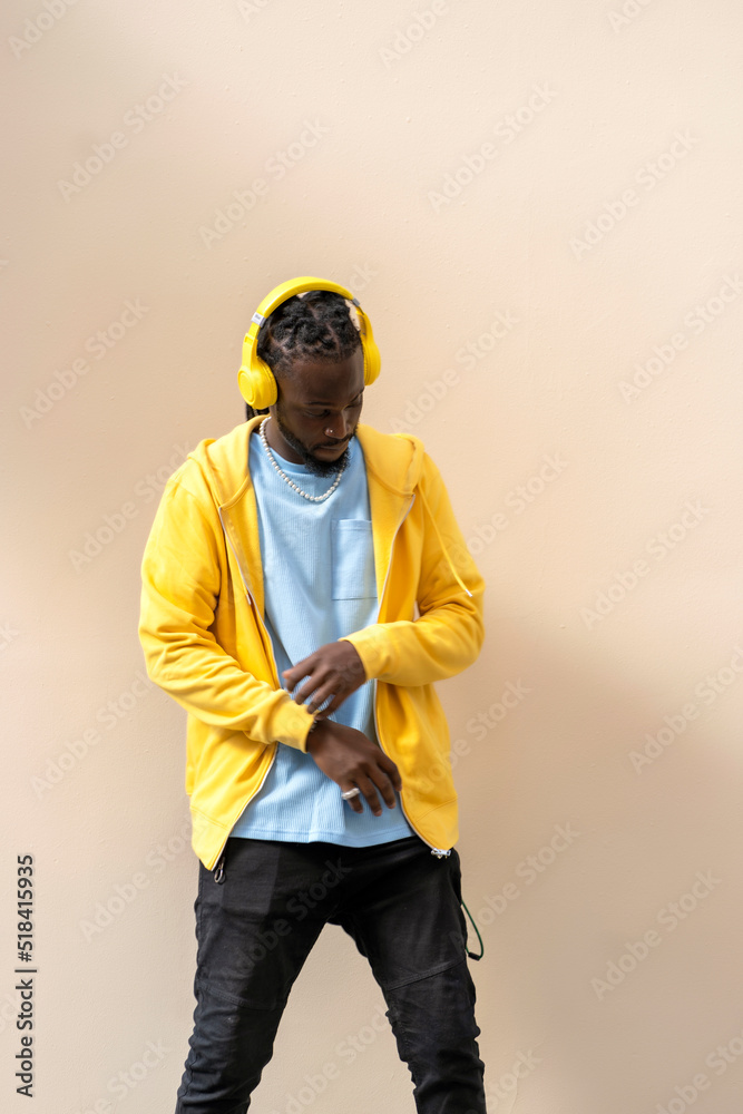 © Cavan Images - african man dancing to the rhythm of the music with his headphones © Cavan Images - african man dancing to the rhythm of the music with his headphones