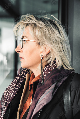 A mature woman walking outdoors in the sity