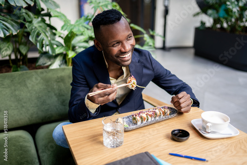 Businessman Eating Sushi For Lunch photo