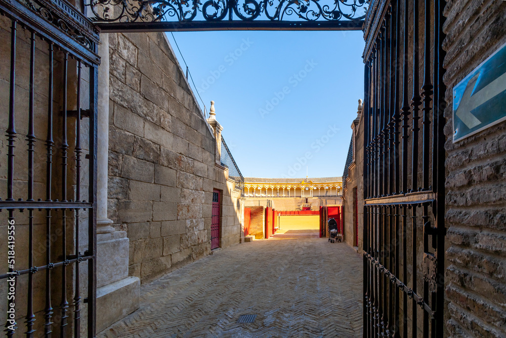 An entrance into the Plaza de toros de la Real Maestranza de Caballería de Sevilla, the historic bullring in the historic center of Seville, Spain. An entrance into the Plaza de toros de la Real Maestranza de Caballería de Sevilla, the historic bullring in the historic center of Seville, Spain.