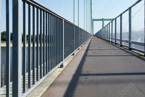 footpath of a highway bridge over the rhine separated from the roadway by glass noise barriers photo
